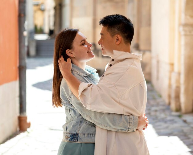 Medium shot romantic couple outside