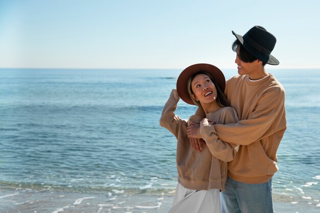 Medium shot romantic couple at seaside