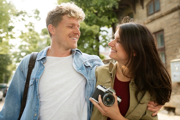 Free photo medium shot romantic couple with camera