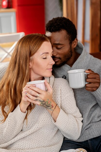 Medium shot romantic couple with cups