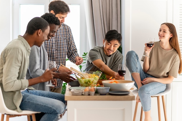 Medium shot roommates sitting at table