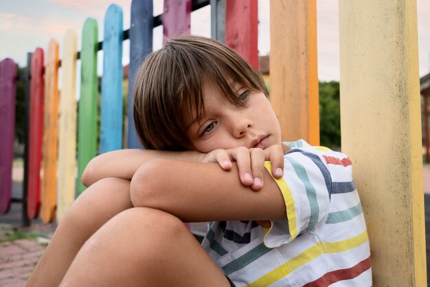 medium shot  sad boy in park