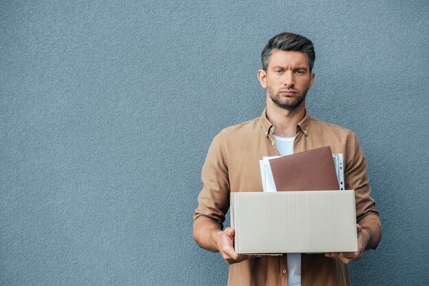 Medium shot sad man holding box