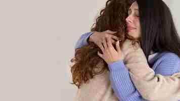 Free photo medium shot sad woman hugging