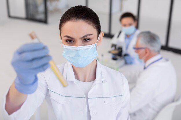 Free photo medium shot scientist holding tube