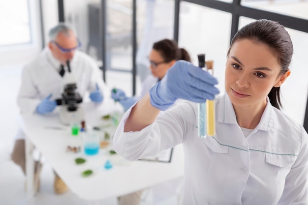 Medium shot scientist holding tubes