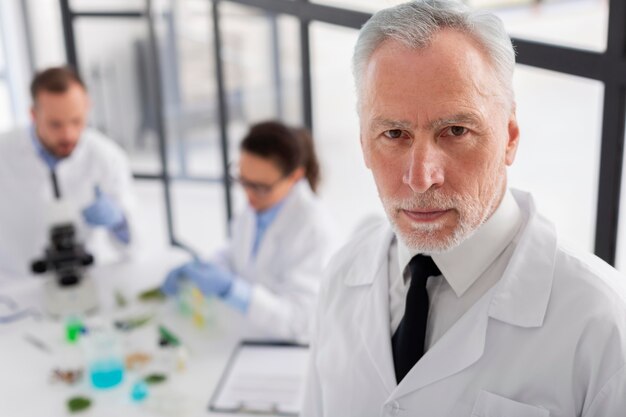 Medium shot scientist wearing lab coat
