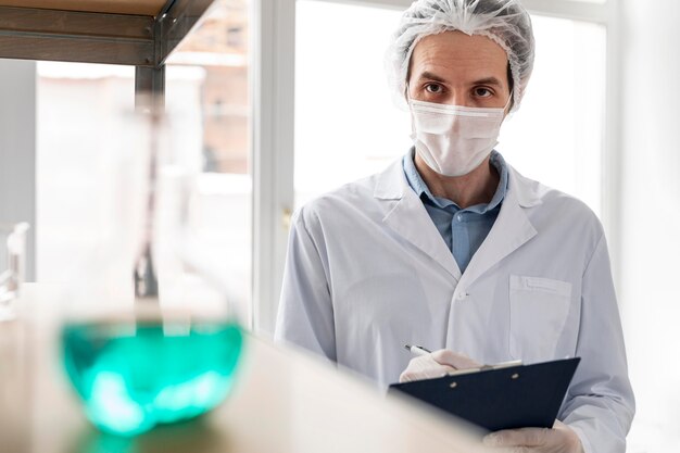 Medium shot scientist wearing mask