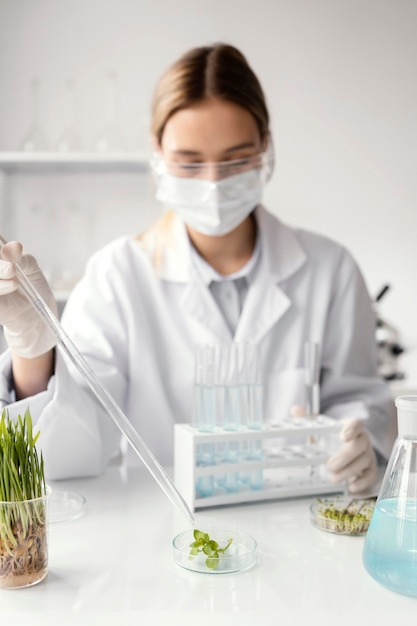 Medium shot scientist wearing mask