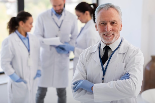 Free photo medium shot scientists with lab coats