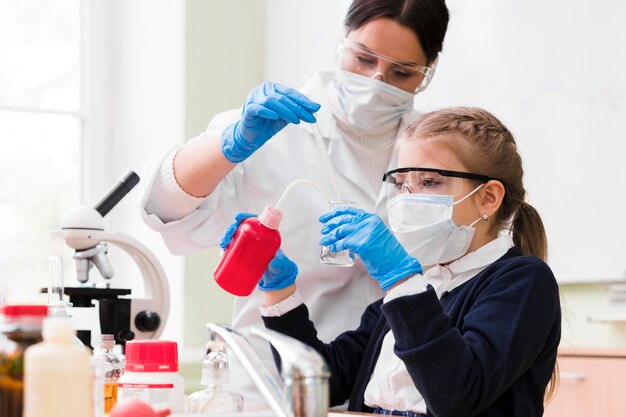 Medium shot scientists with masks