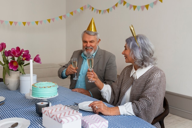 Medium shot senior couple celebrating birthday