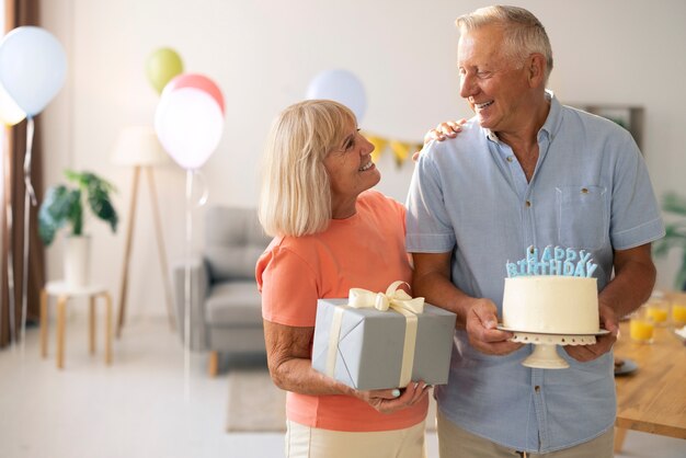 Medium shot senior couple celebrating birthday