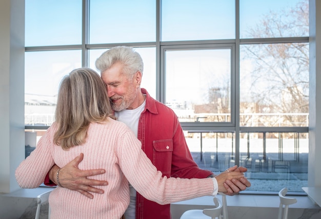 Free photo medium shot senior couple dancing together