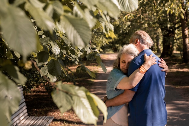 Medium shot senior couple hugging