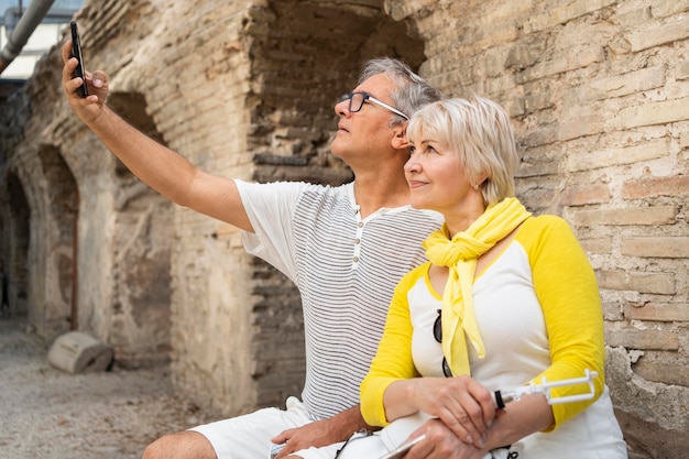 Medium shot senior couple taking selfie