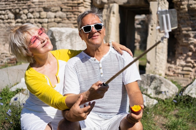 Medium shot senior couple taking selfie