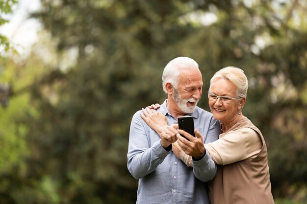 medium shot senior couple taking selfie