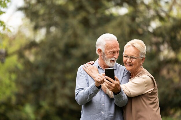 Medium shot senior couple taking selfie
