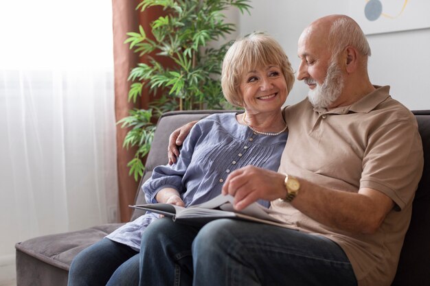 Medium shot senior couple with book