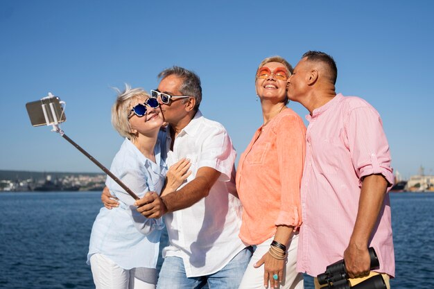 Medium shot senior couples taking selfie