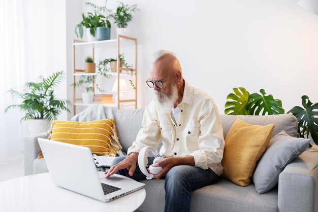 Medium shot senior man holding headphones