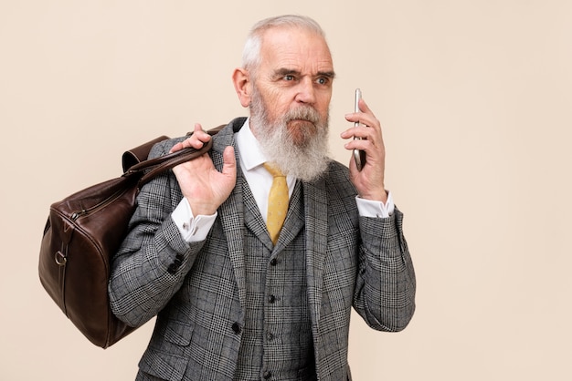 Medium shot senior man holding smartphone