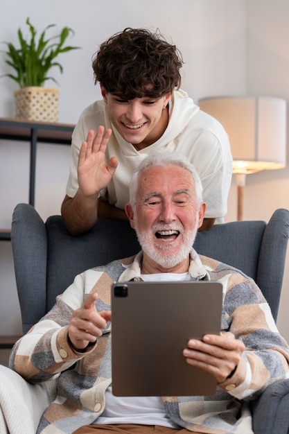 Medium shot senior man holding tablet