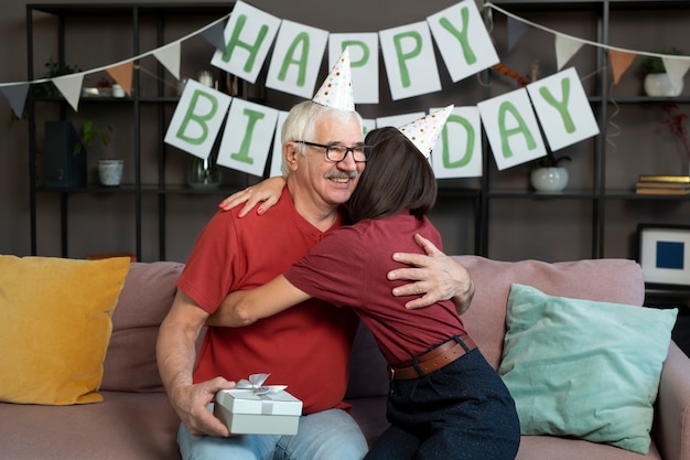 Free photo medium shot senior man hugging woman