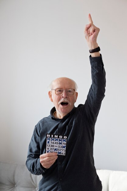 Medium shot senior man playing bingo