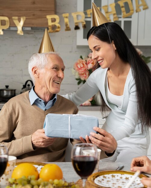 Medium shot senior man receiving present