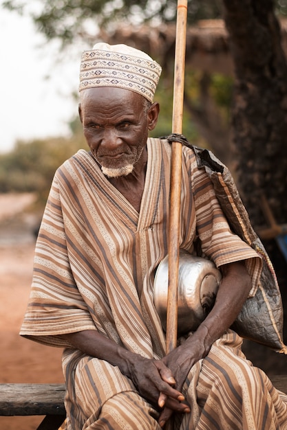 Medium shot senior man sitting outdoors