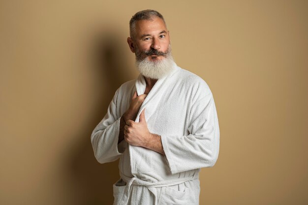 Medium shot senior man wearing bathrobe