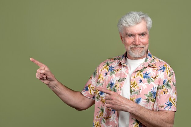 Medium shot senior man with green background