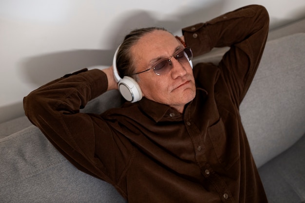 Medium shot senior man with headphones