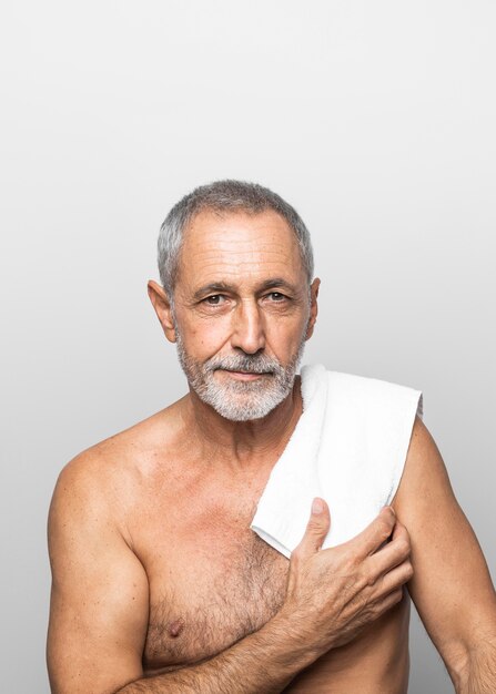Medium shot senior man with towel