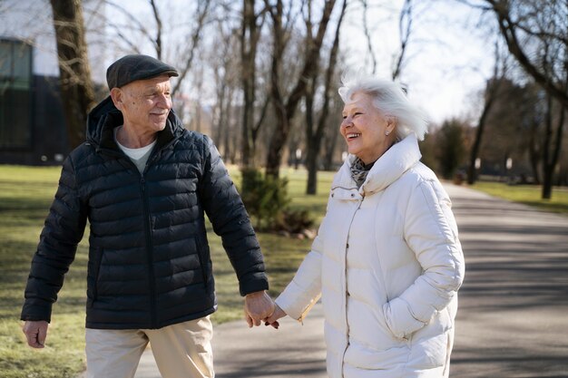 Medium shot senior people holding hands