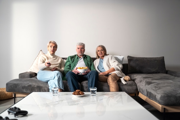 Medium shot senior people sitting on couch