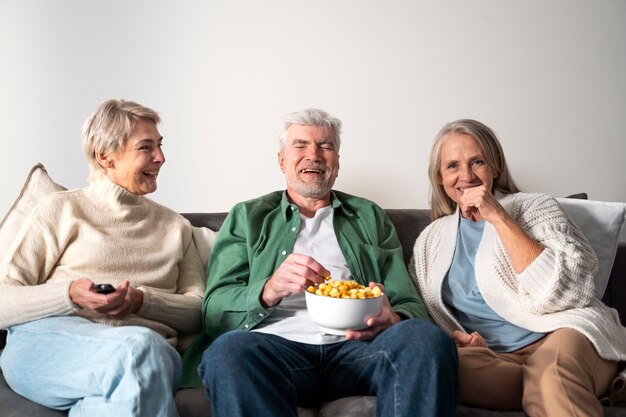 Medium shot senior people sitting together