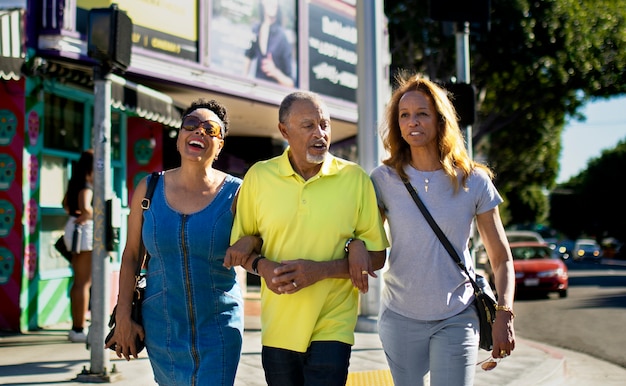 Free photo medium shot senior people walking in city