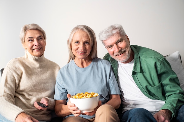 Foto gratuita persone anziane a tiro medio con popcorn