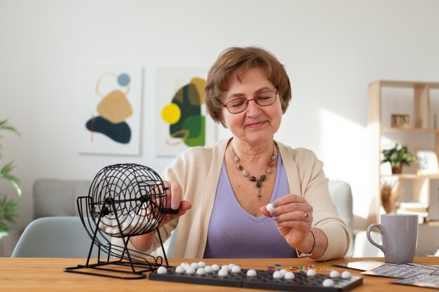 Medium shot senior woman playing bingo