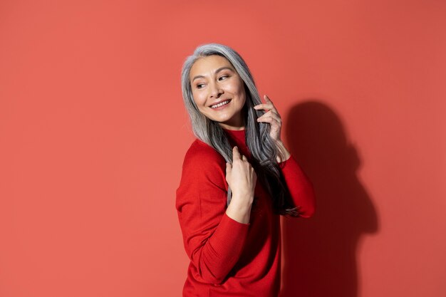 Medium shot senior woman posing at studio