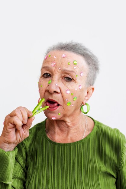 Medium shot senior woman posing in studio