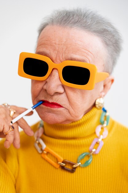 Medium shot senior woman posing in studio