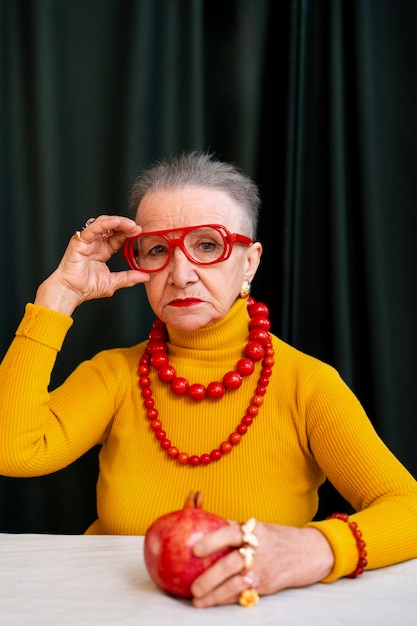 Medium shot senior woman posing in studio