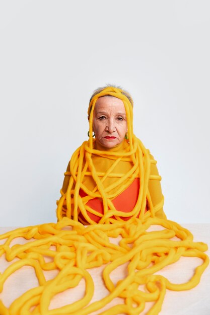 Medium shot senior woman posing in studio