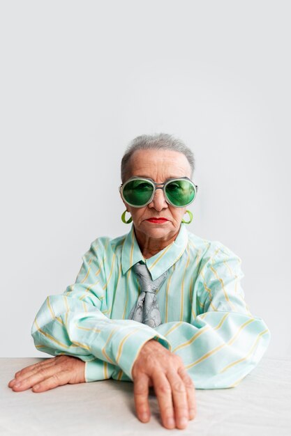 Medium shot senior woman posing in studio