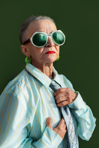 Medium shot senior woman posing in studio