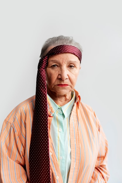 Free photo medium shot senior woman posing in studio